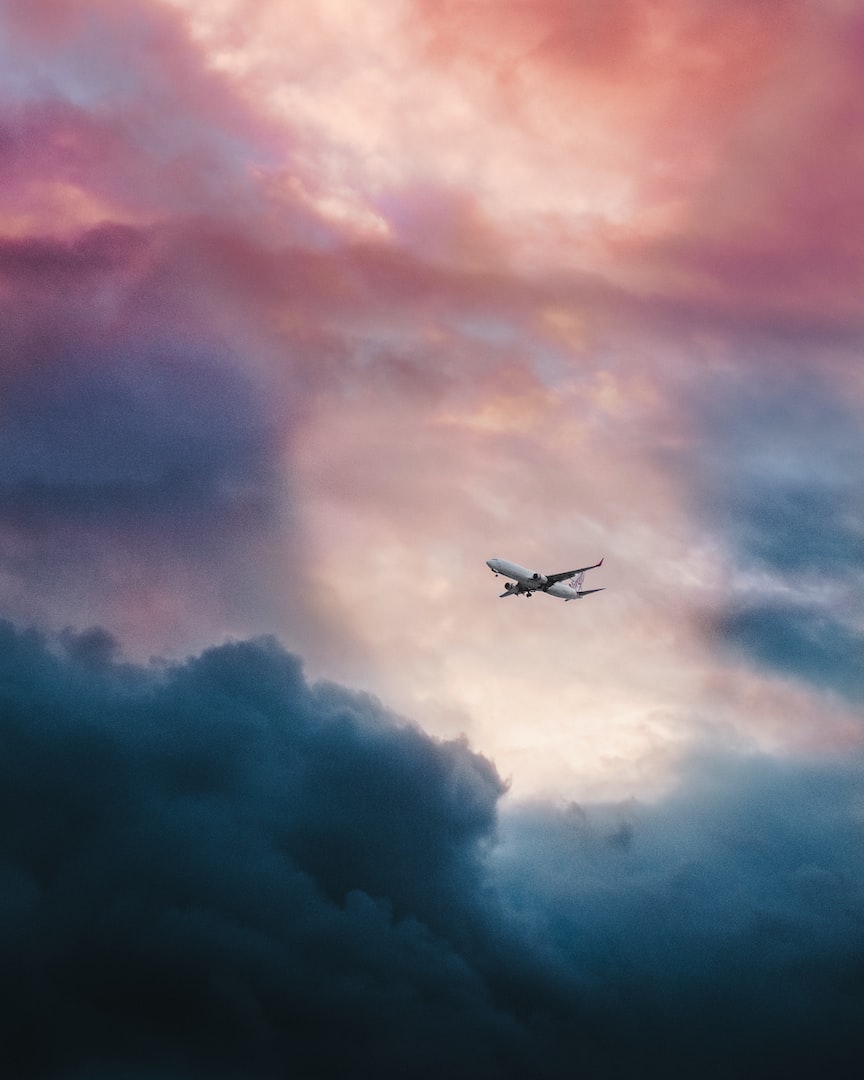Airplane in sky with dark blue purple clouds
